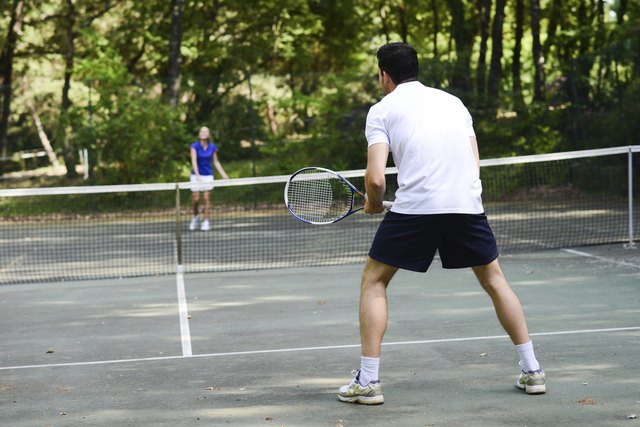 young couple playing tennis outdoor summer