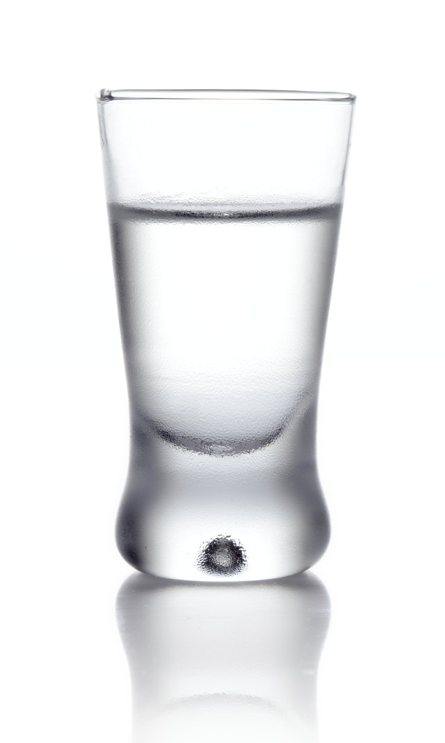 Glass of vodka isolated on white
