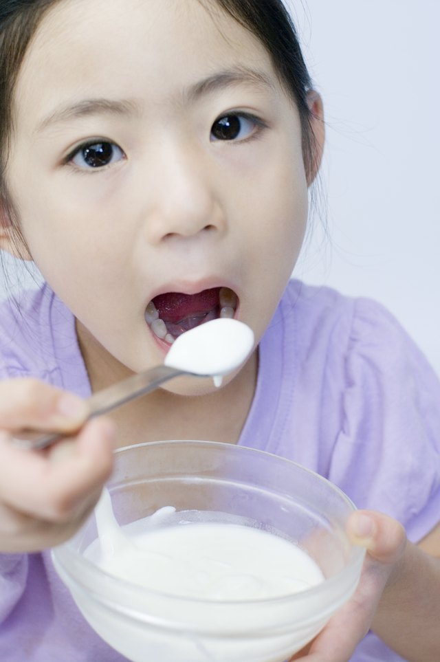 Little Girl Eating Yoghurt