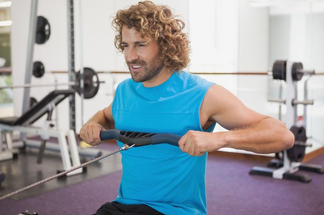 Handsome man using resistance band in gym