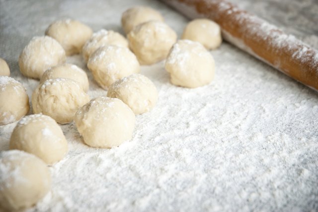 Prepared dough in ball shape on silver tray