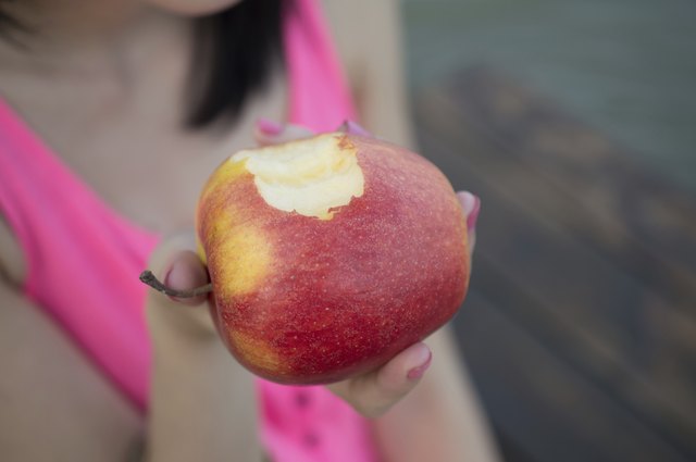 Beautiful girl eating fresh apple