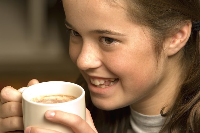 Teenage girl with hot beverage