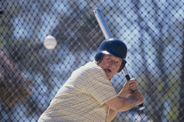 Senior man playing baseball
