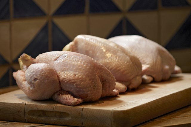 Uncooked chickens in kitchen