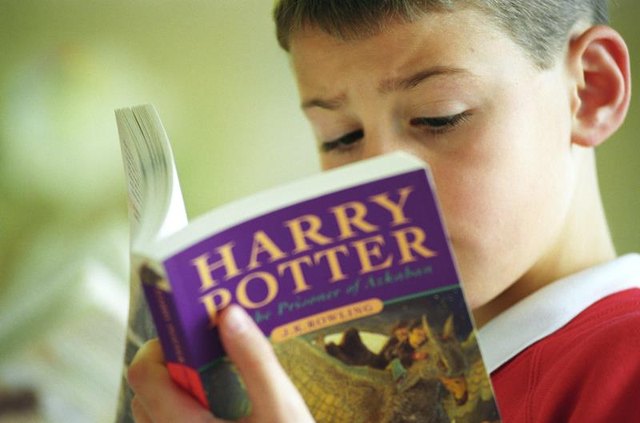 A young boy reads “Harry Potter and the Prisoner of Azkaban” by J.K. Rowling in a book shop in Shirley, Birmingham, U.K.