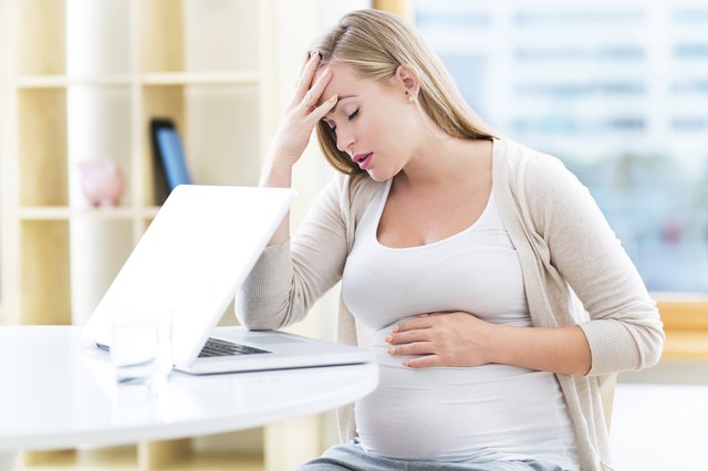 Tired pregnant woman working