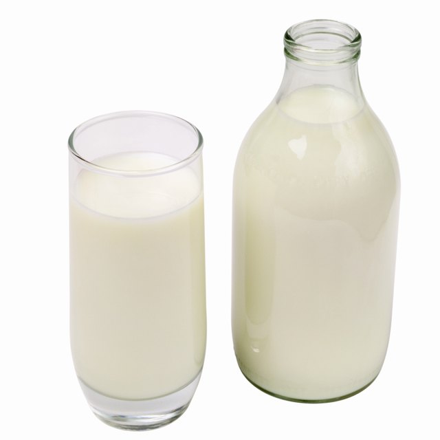 Close up of a glass of milk and a bottle of milk