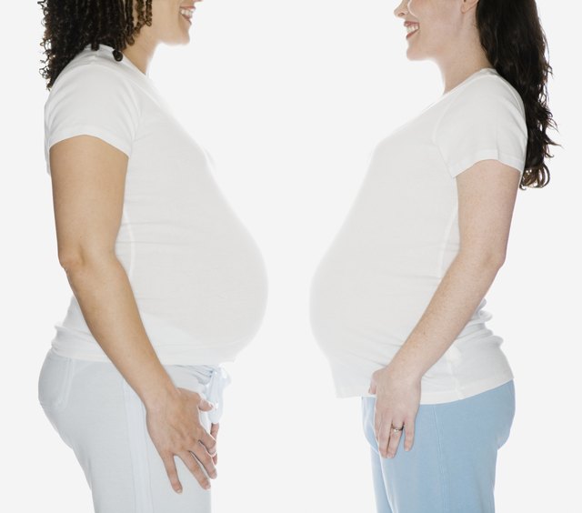 Multi-ethnic pregnant women facing each other