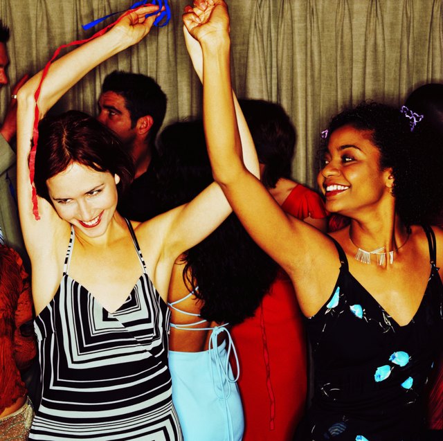 view of two young women dancing at a party