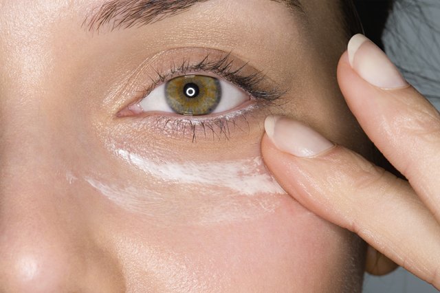 Woman applying moisturiser