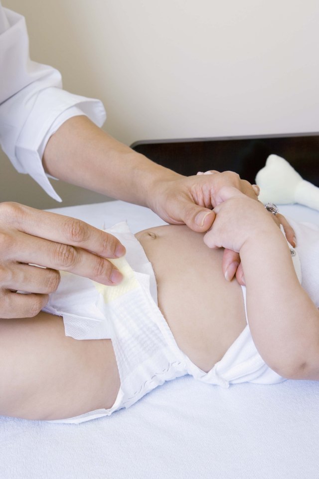 Mother with baby on changing table