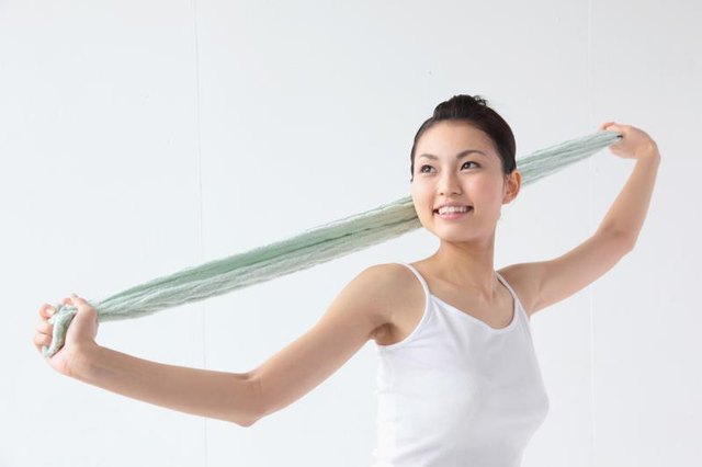 Woman stretching with a towel