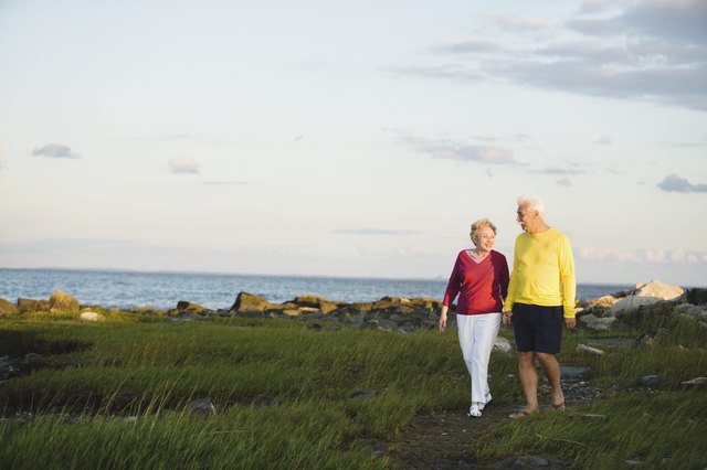 Senior couple walking near ocean