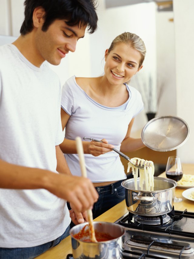 young couple cooking food in the kitchen