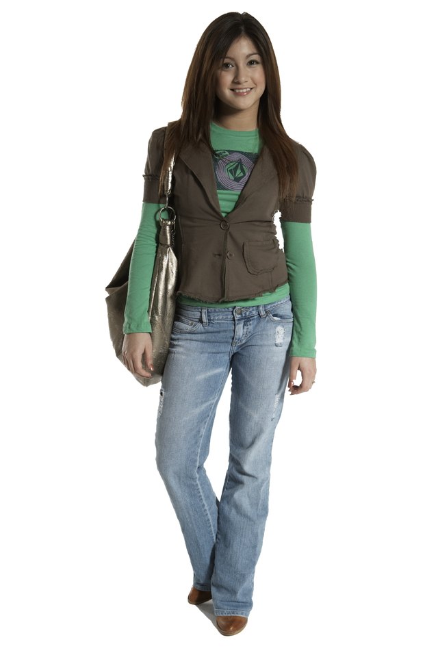 Teenage girl (15-17) carrying purse, smiling, portrait