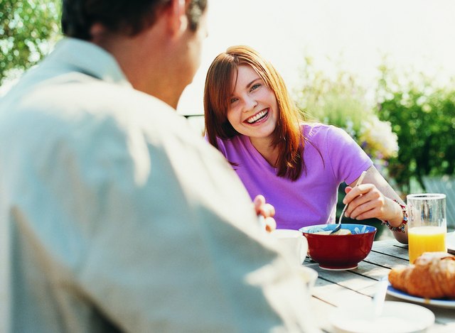 Couple Having Breakfast in Their Garden in Summer