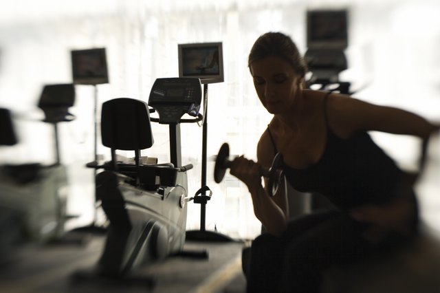 Woman lifting weights in gym