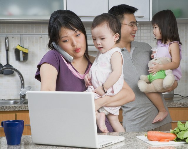 Family in kitchen with laptop