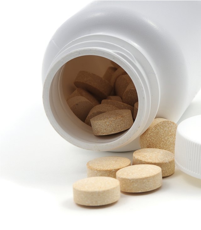 Pills spilling out of a jar 2