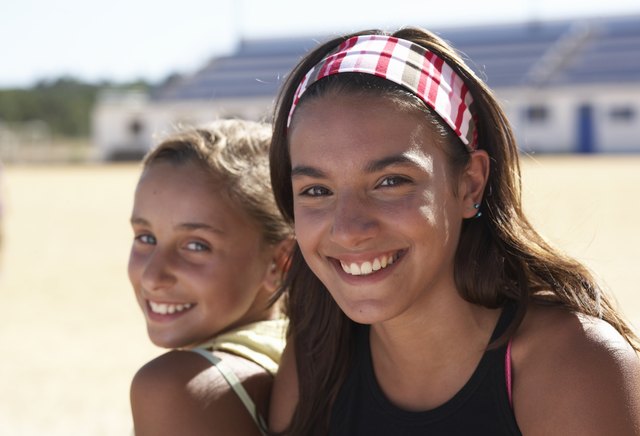 Portrait of two girls (12-14) smiling, outdoors