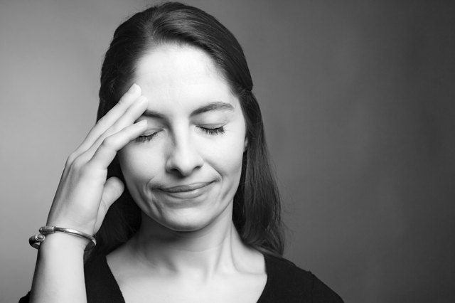 Woman with hand on head