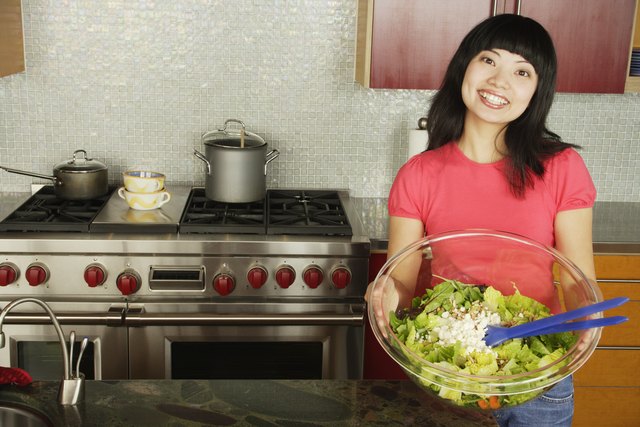 Woman holding salad serving bowl