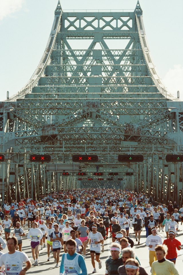 People running marathon on bridge