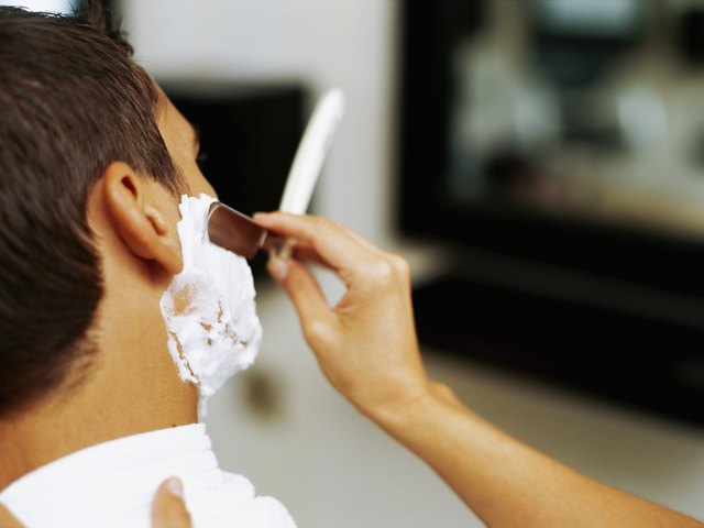 barber shaving a man
