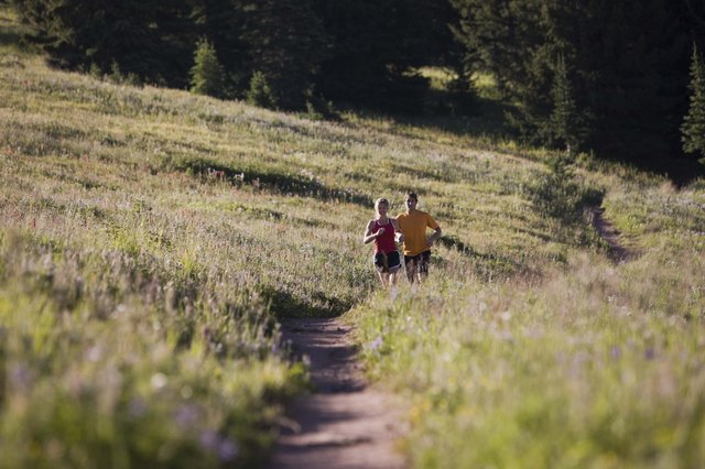 People running along path on hillside