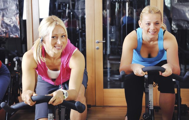 Beautiful women doing exercise in a spinning class at gym