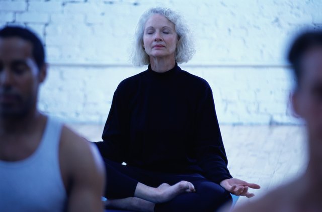 Woman in the Lotus Position in a Yoga Class