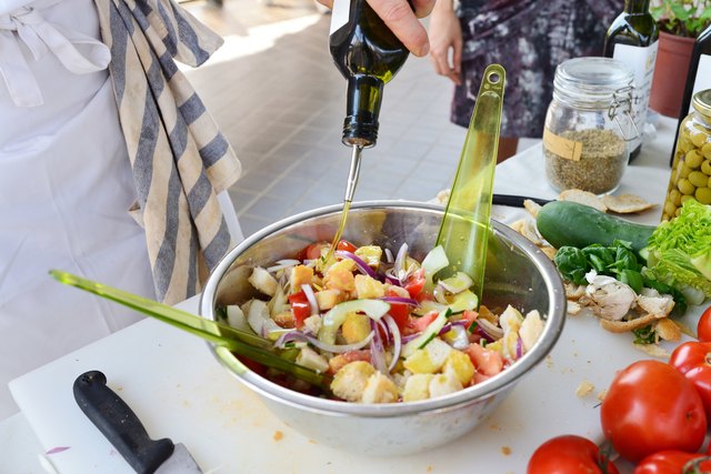 Caucasian man preparing food (salad cooking lesson)