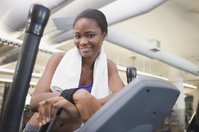 Fit woman working out on the cross trainer