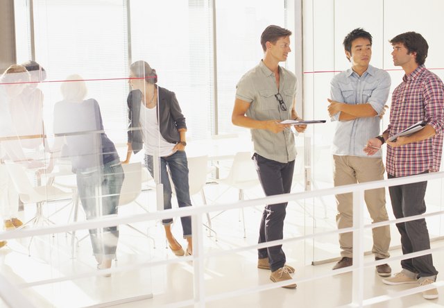 Businessmen meeting in doorway conference room