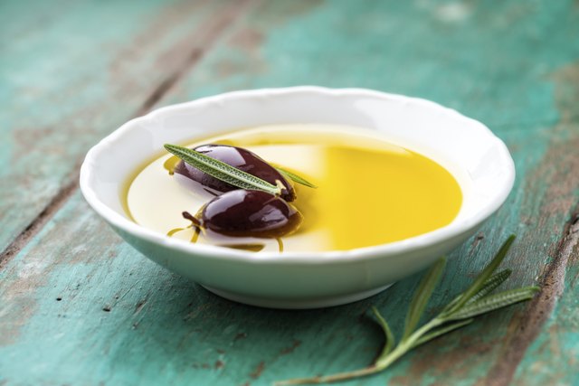 Kalamata olives in a bowl of olive oil
