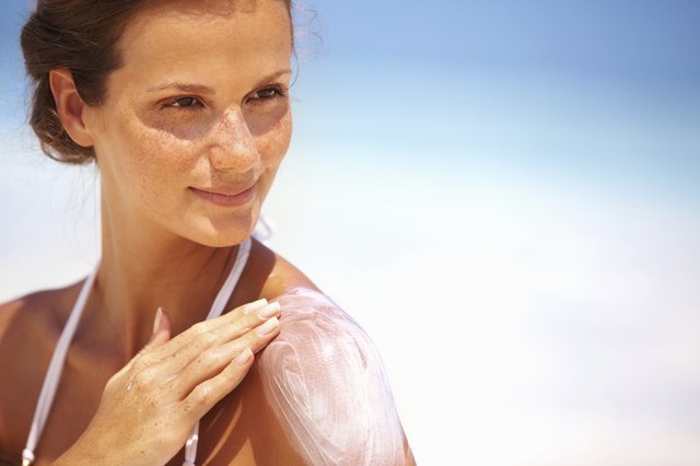 Lovely woman applying lotion