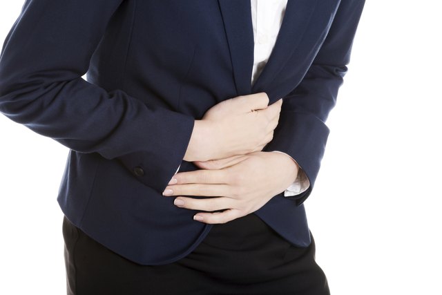 Beautiful business woman is touching her stomach.