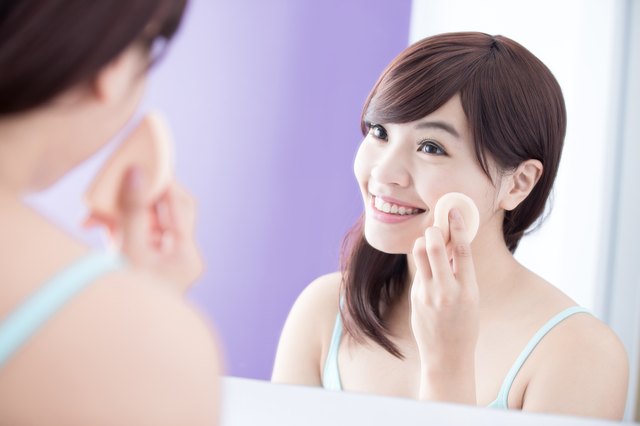 Smile woman with cosmetic sponge