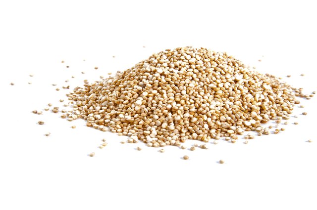 Handful of Quinoa on a white background.