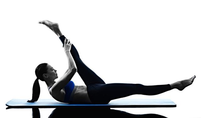 one caucasian woman exercising pilates exercises fitness in silhouette isolated on white backgound