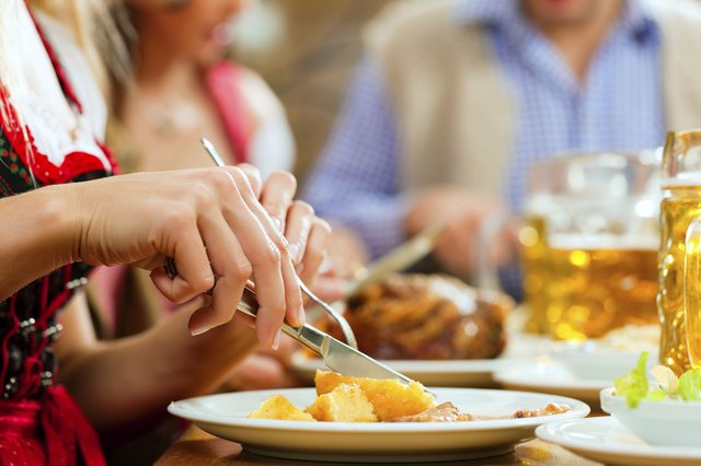 People eating roast pork in Bavarian restaurant