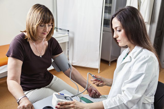 Doctor Checking Blood Pressure To A Patient