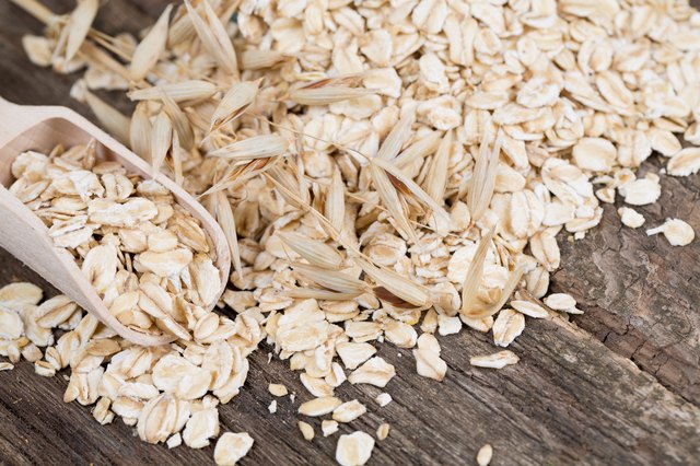 oat flakes in a spoon on wooden surface
