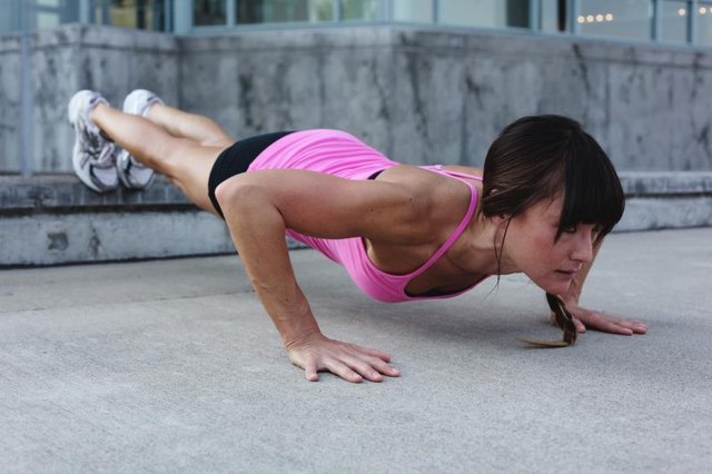 Woman does a decline pushup showing strength and proper form