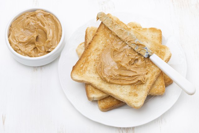 toast with peanut butter on a plate, top view
