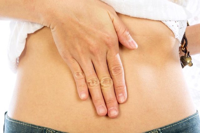 Young woman is having stomach ache Isolated on white background