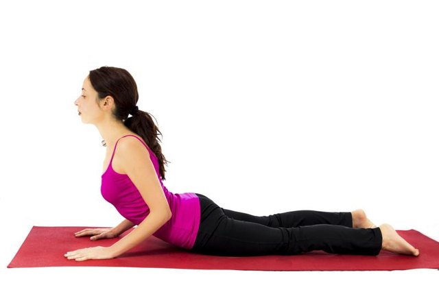 Woman doing Cobra pose for stretching (Series with the same model available)