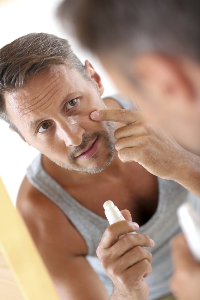 Middle-aged man applying wrinkle corrector