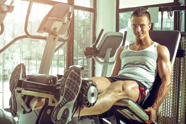 Man doing leg extension in gym